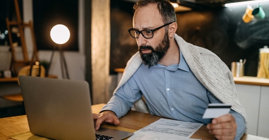 Man at his computer with his coffee