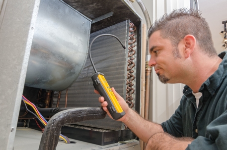 Technician fixing a furnace not working