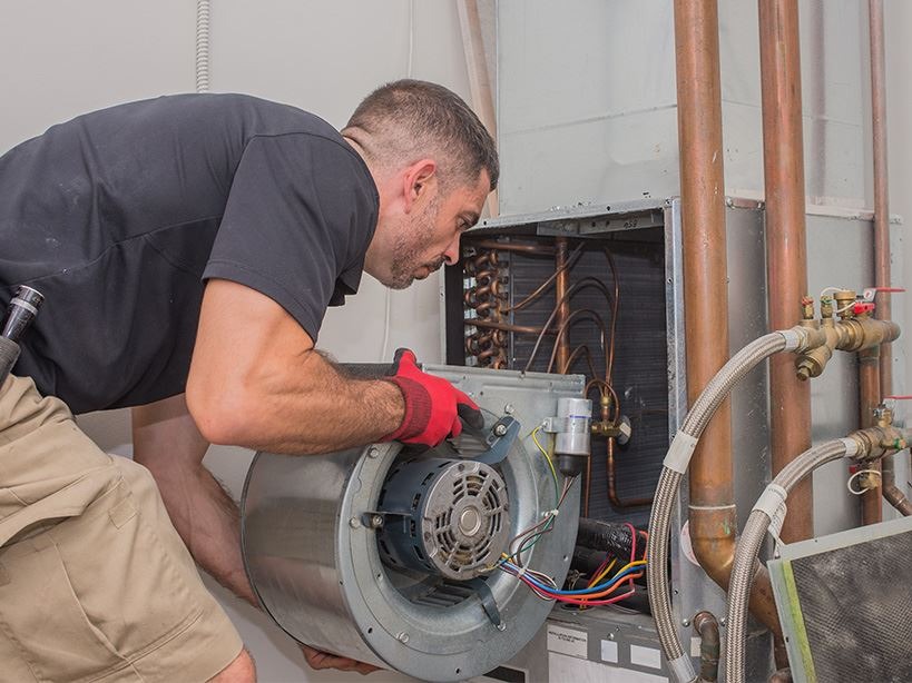 Tech checking out HVAC unit